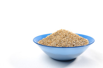 Blue bowl of barley grits isolated on white