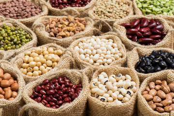 Different dry legumes in burlap bag
