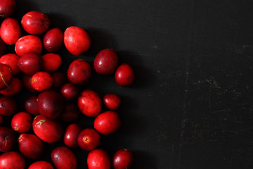 Cranberries on a black wood background