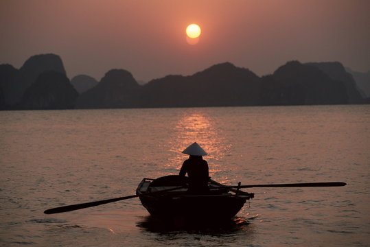 Woman rowing woven skiff, Ha Long Bay (Ha-Long Bay), Vietnam 