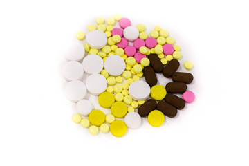 Pharmacy theme. Multicolored Isolated Pills and Capsules on the White Surface. Closeup