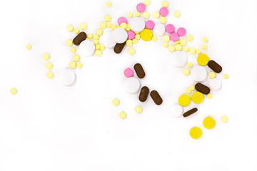 Pharmacy theme. Multicolored Isolated Pills and Capsules on the White Surface. Closeup
