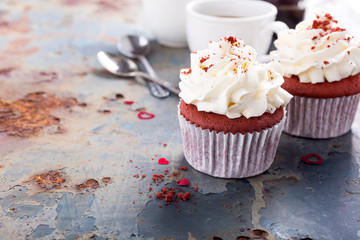 Delicious red velvet cupcakes for Valentines Day on rusty old metal background. Holiday food concept. Copy space.