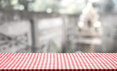 Fabric tabletop with blurry building with concrete wall backgrou