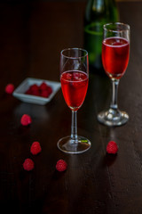 Raspberry Mimosa with blood orange on dark wood background