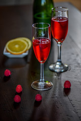Raspberry Mimosa with blood orange on dark wood background