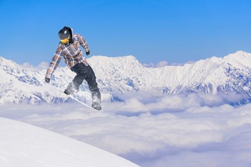 Naklejka na ściany i meble Snowboard rider jumping on mountains. Extreme sport.
