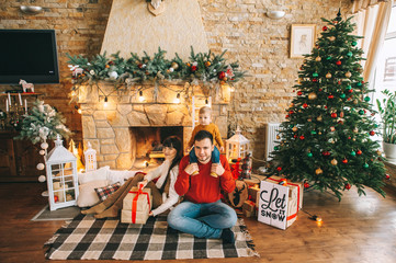 Young family in Christmas interior