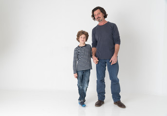 Cheerful mature man posing in studio with his son