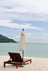 Empty folding lounge chair on the sand beach