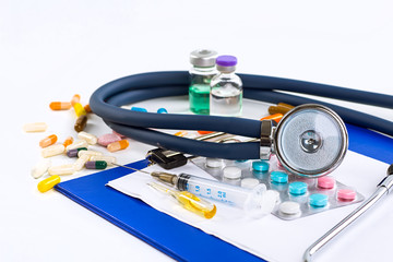 Stethoscope, pills and bottles on color background. medicine con
