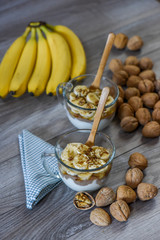 Granola with yogurt, bananas and whole walnuts, maple syrup clea