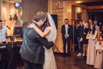 Bride and groom dancing at wedding reception. Newlyweds dance.