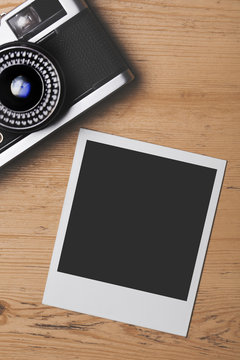 Blank vintage instant photograph with a retro camera