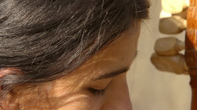 closeup footage on young woman playing a old string instrument