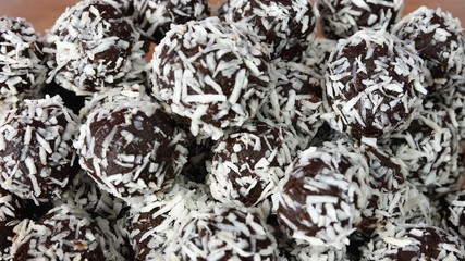 Christmas sweets on a plate - Rum balls in coconut. Traditional homemade handmade Czech sweets.