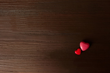 Love background, two red hearts on wooden background with copy space. Ready for design, made with...
