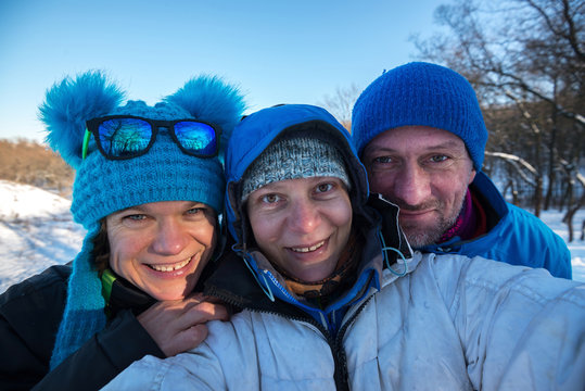 Happy friends taking selfie after skiing