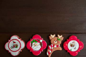 Christmas background, colorful gingerbreads on wooden background with copy space.Christmas sweets