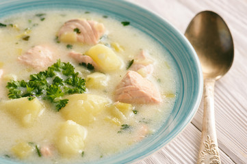 Potato soup with salmon, leek, sour cream and parsley.