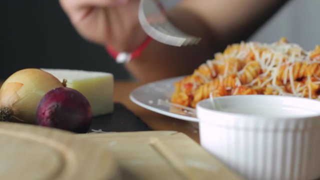 Hot Pasta with tomato Sauce, Parmesan Cheese on a Spoon