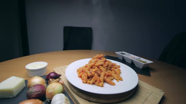 Hot Pasta with tomato Sauce, Parmesan Cheese on a Spoon
