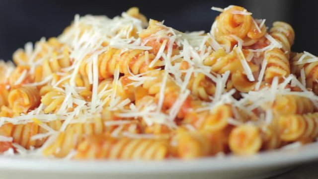 Hot Pasta with tomato Sauce, Parmesan Cheese on a Spoon
