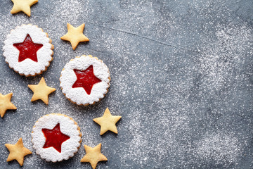 Linzer star cookies with jam filling flat lay traditional Christmas homemade winter Austrian sweet dessert food Xmas celebration pastry powdered holiday snack on vintage table background.