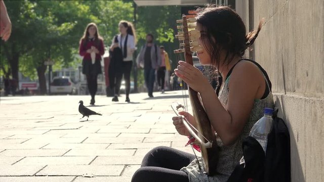beggar street artist on the sidewalk 