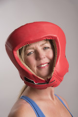 Portrait of a female boxer wearing red head guard and gloves
