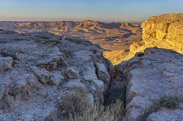 First light of the day strikes the rim of the Ramon Crater