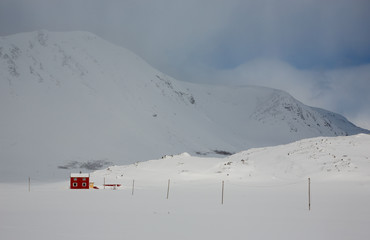 A red house in an arctic landscape