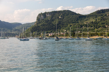 Fototapeta na wymiar Sailboats at Porto di Bardolino harbor on The Garda Lake . Italy
