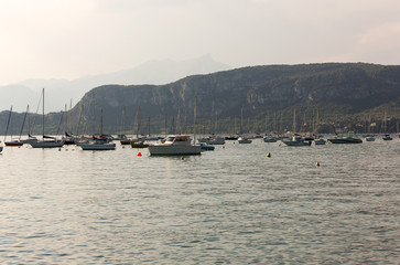 Fototapeta na wymiar Sailboats at Porto di Bardolino harbor on The Garda Lake . Italy