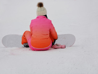 Female snowboarder in pink clothes