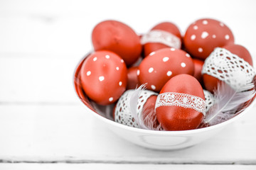 Red Easter eggs on a white plate