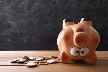 Concept of spending the savings with piggy bank upside down