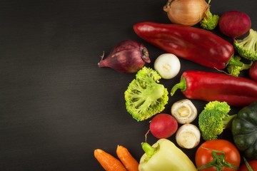 Freshly harvested organic vegetables on a wooden table. Vegetables on vintage wood background - autumn harvest. Rural still life from above with free text space.
