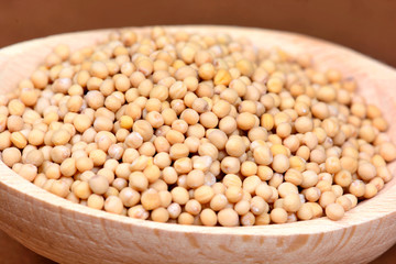 Wooden bowl with mustard seeds