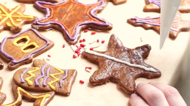Women decorating gingerbread with light blue glaze