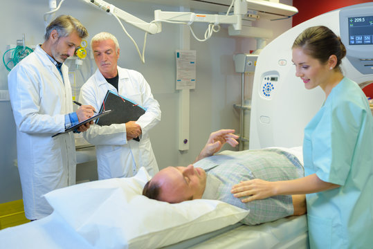 Nurse reassuring patient having scan