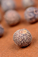 Allspice on brown background