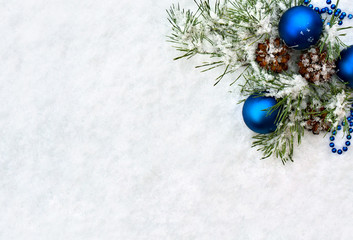 Fototapeta na wymiar Christmas decoration. Branch pine tree, blue christmas ball and cones pine on snow. Top view, flat lay