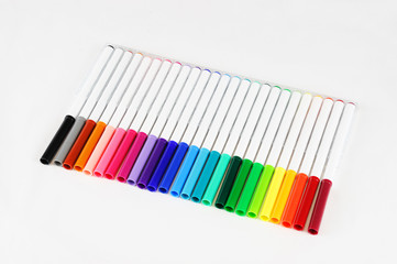 colorful markers in a row isolated on white background