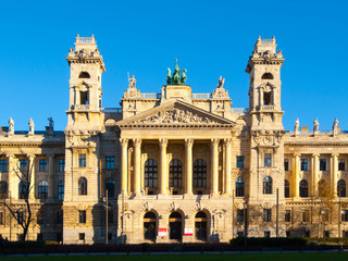 Fototapeta premium Hungarian National Museum of Ethnography, aka Neprajzi Muzeum, at Kossuth Lajos Square in Budapest, Hungary, Europe. Front view of entrance portal with two towers and architectural columns on sunny