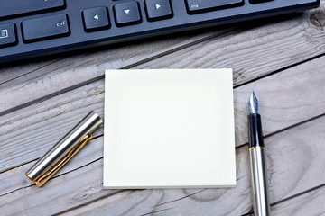 Empty notes with fountain pen and keyboard pc