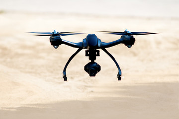drone landing on the sand - obrazy, fototapety, plakaty