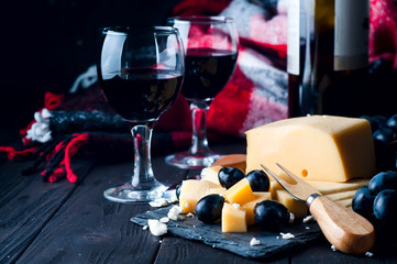 two glasses of red wine and cheese