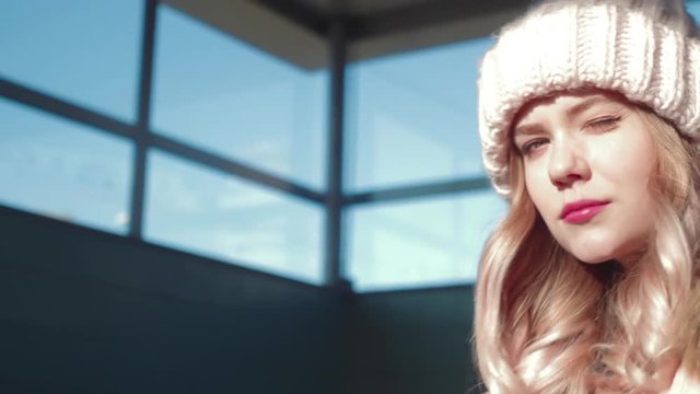 Beautiful blonde young girl fashion look and smile with blue background and sun