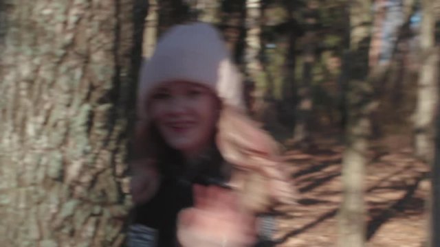 Beautiful blonde young girl have fun at the autumn sunny wood smiling and run